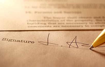 Client signing documents for tree removal in Toronto permit application, guided by a licensed arborist for compliance.